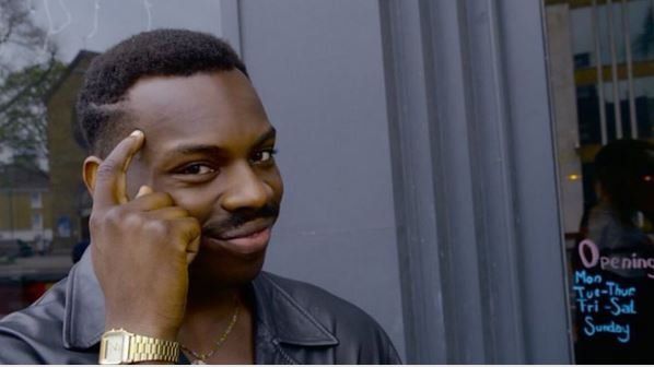 a man is thinking with his finger on his forehead .