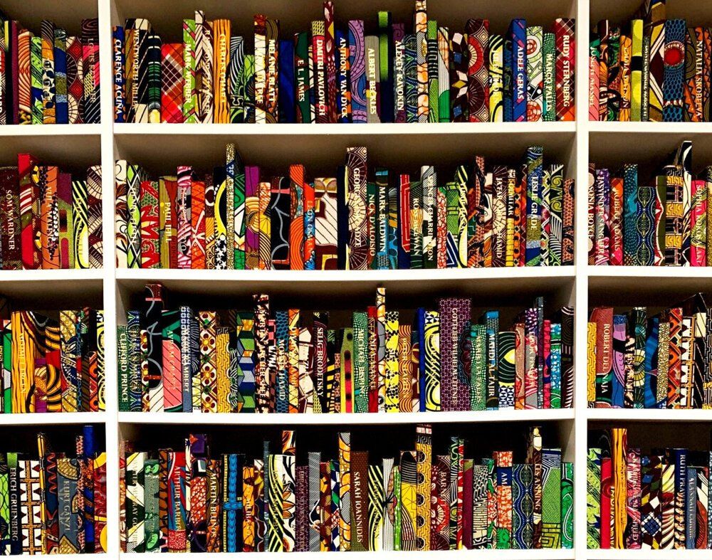 a bookshelf filled with lots of colorful books including one that says ' african ' on it