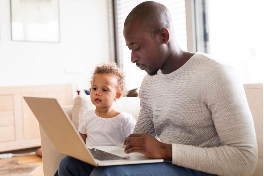 Father with son in remote work on a labtop