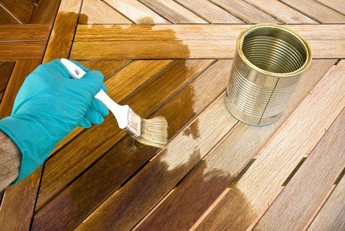 Wooden table getting protective coating