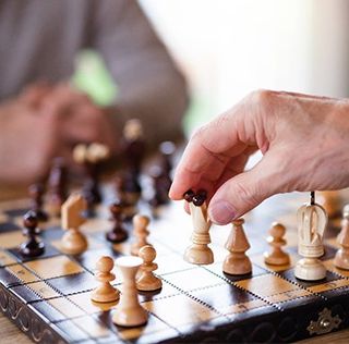 Playing Chess — Waite Park, MN — Total Recreation Couple Playing Darts — Waite Park, MN — Total Recreation