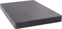 A black rectangular piece of foam is sitting on a white surface.