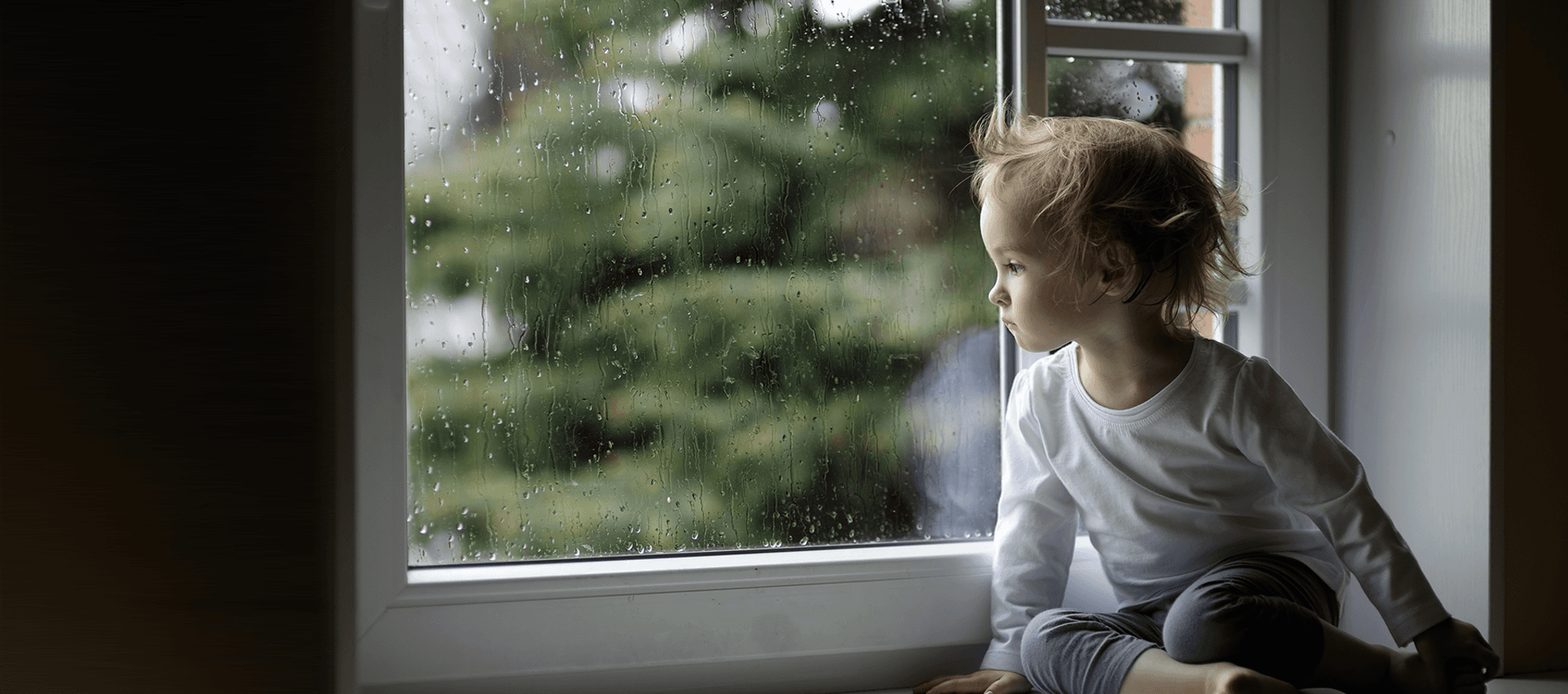 a boy peeping out of the window