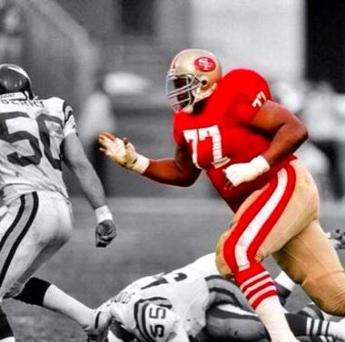 A football player with the number 77 on his jersey