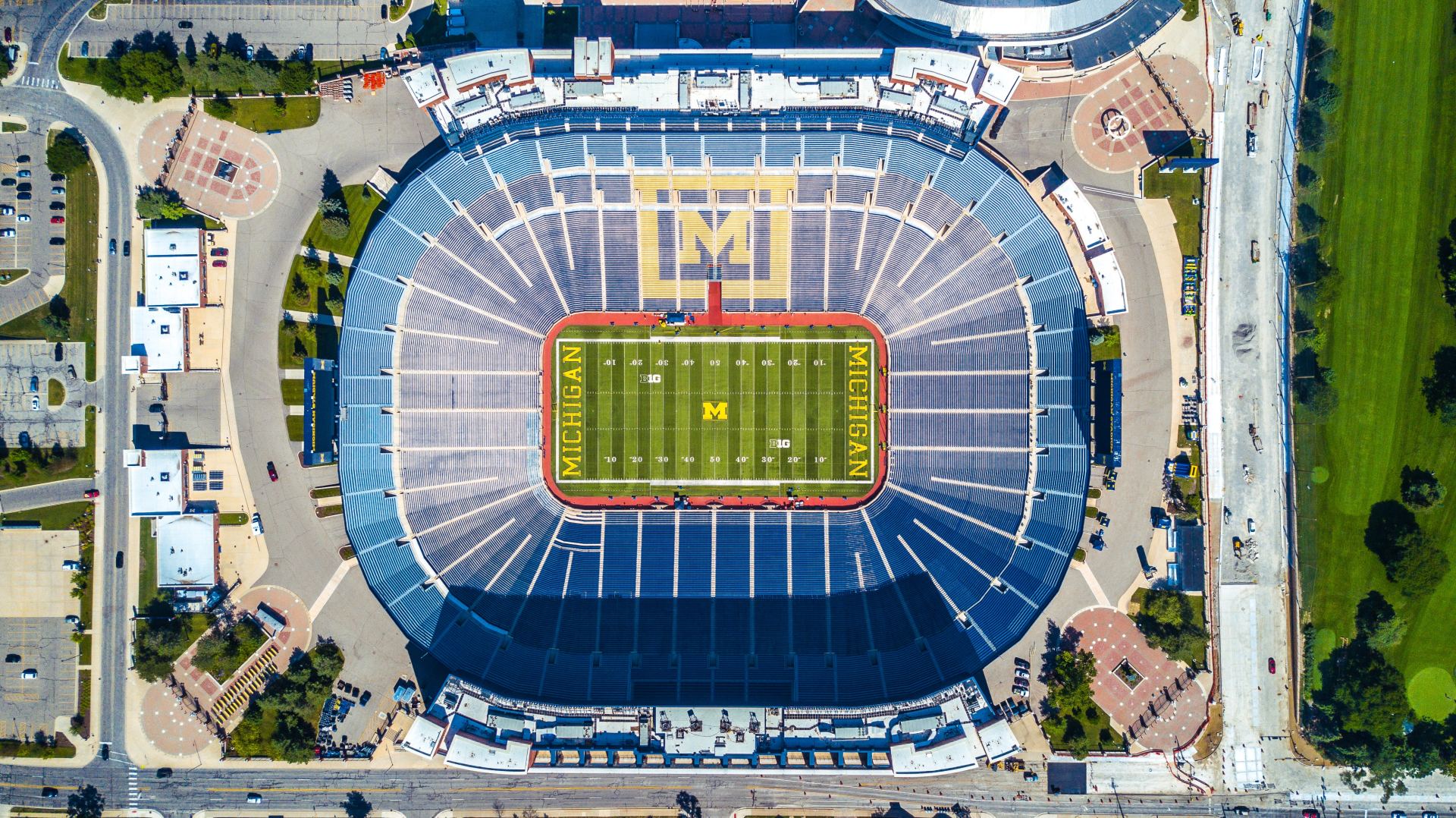 An aerial view of a football stadium with a field in the middle.