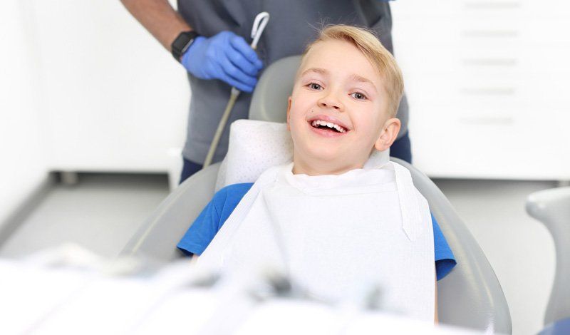 Boy Smiling During Dental Checkup — Bismarck, ND — A Lifetime of Smiles Boy Smiling During Dental Checkup — Bismarck, ND — A Lifetime of Smiles