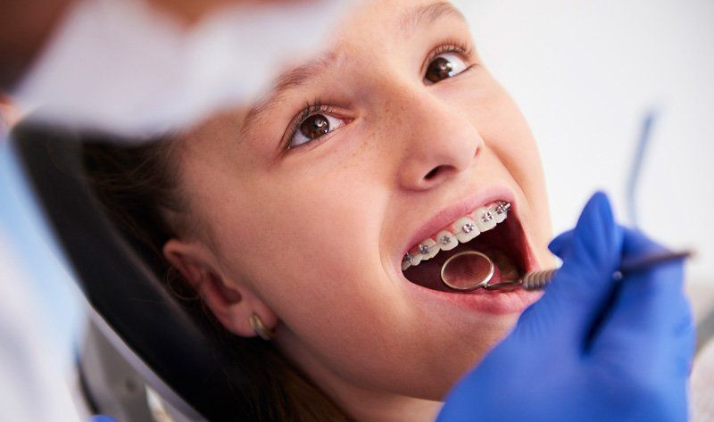 Teen Girl With Dental Braces — Bismarck, ND — A Lifetime of Smiles