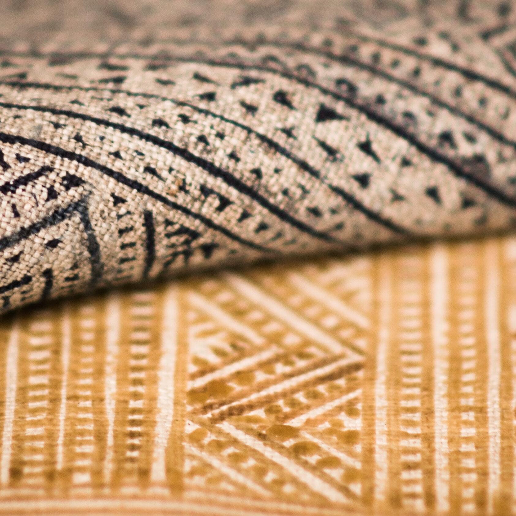 A close up of a rug with a geometric pattern on it.