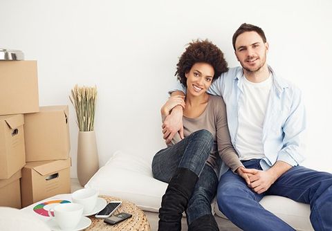 A couple sits in their new home