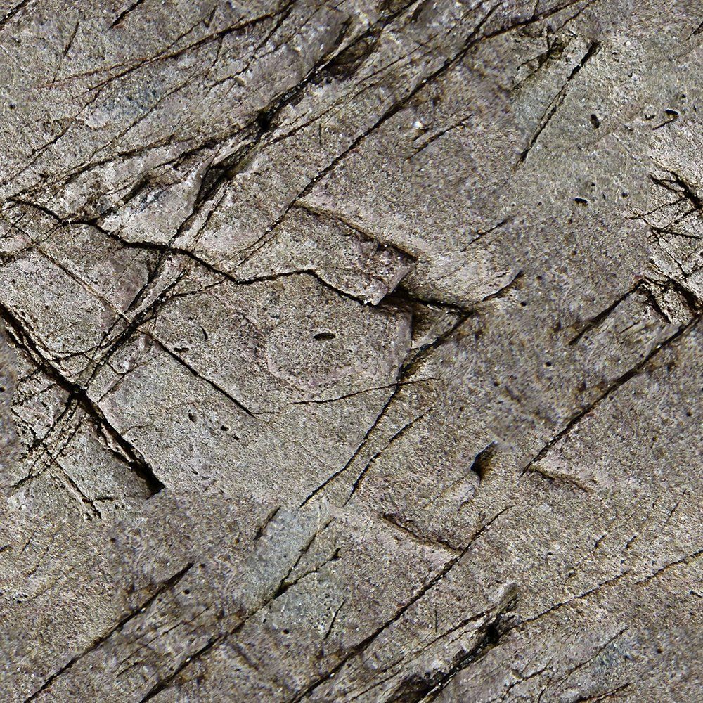 Un primer plano de una textura de roca con muchas grietas.