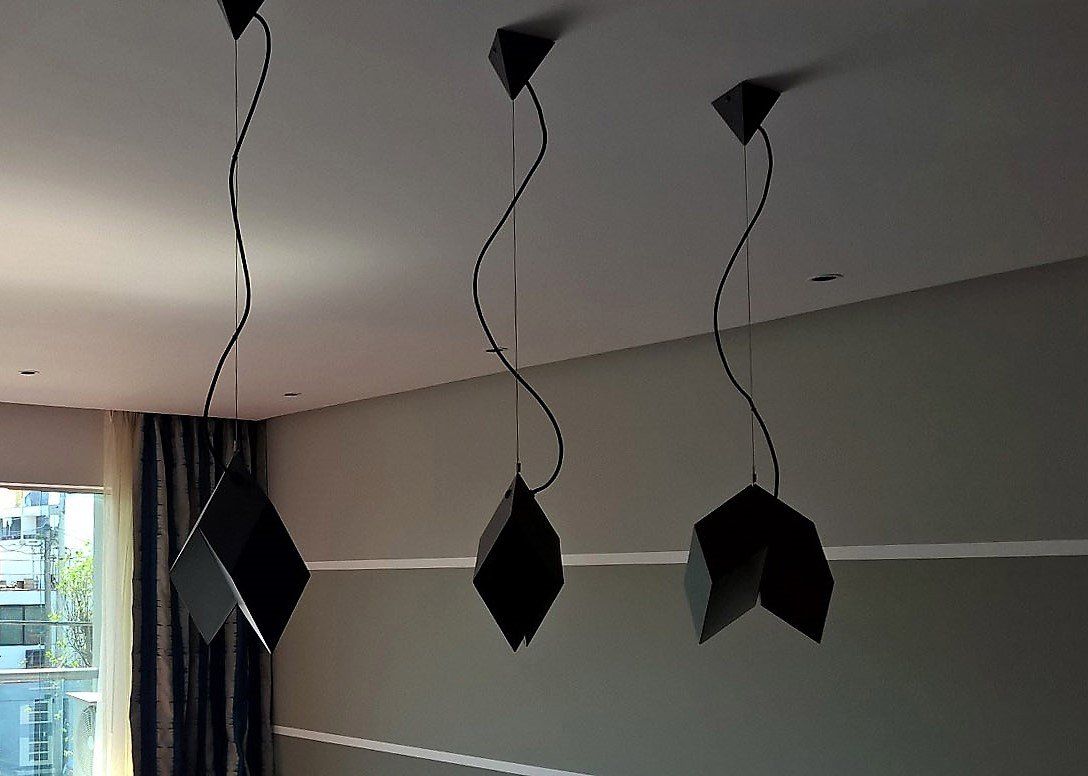 Tres luces negras cuelgan del techo de una habitación.