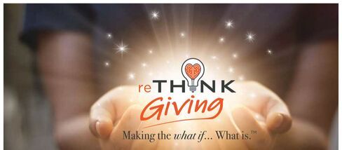 A person is holding something in their hands that says rethink giving.