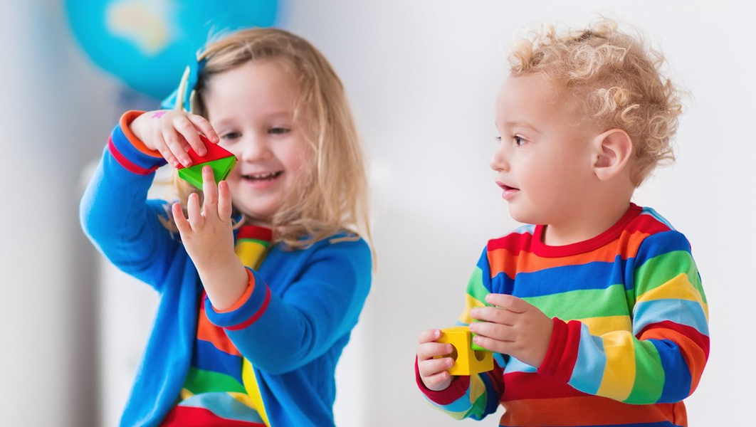Childcare — Two Children Sitting on Ride on Toy in Playroom in Atlanta, GA Childcare — Two Children Sitting on Ride on Toy in Playroom in Atlanta, GA