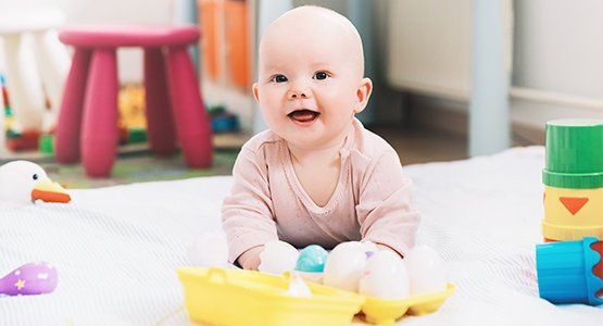 Toddlers — Smiling Baby Playing with Colorful Toys in Atlanta, GA Toddlers — Smiling Baby Playing with Colorful Toys in Atlanta, GA