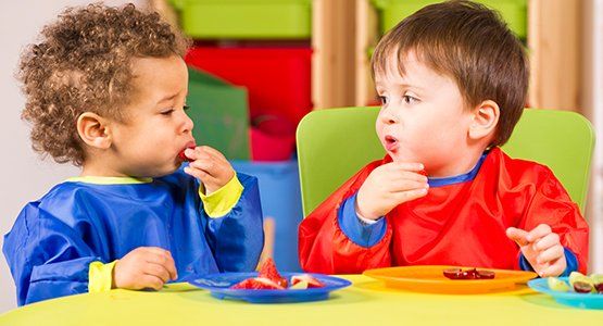 Early Childhood Education — Two Toddlers Eating Fruit in Atlanta, GA Early Childhood Education — Two Toddlers Eating Fruit in Atlanta, GA