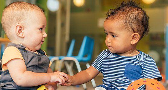 Infants — Babies Playing Together in the Kindergarten in Atlanta, GA Infants — Babies Playing Together in the Kindergarten in Atlanta, GA
