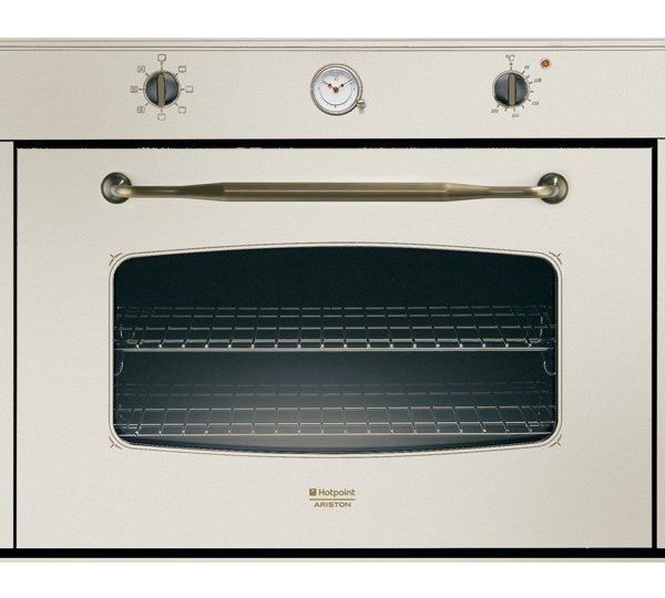 Un forno a incasso color crema, in stile vintage, con maniglia dorata, orologio analogico centrale e due manopole di controllo.