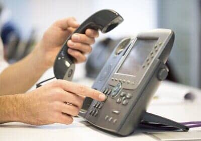 Man hand dialing phone - Cosmetic Dentists in in Newport News, VA