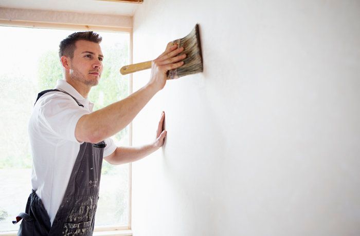 man painting wall