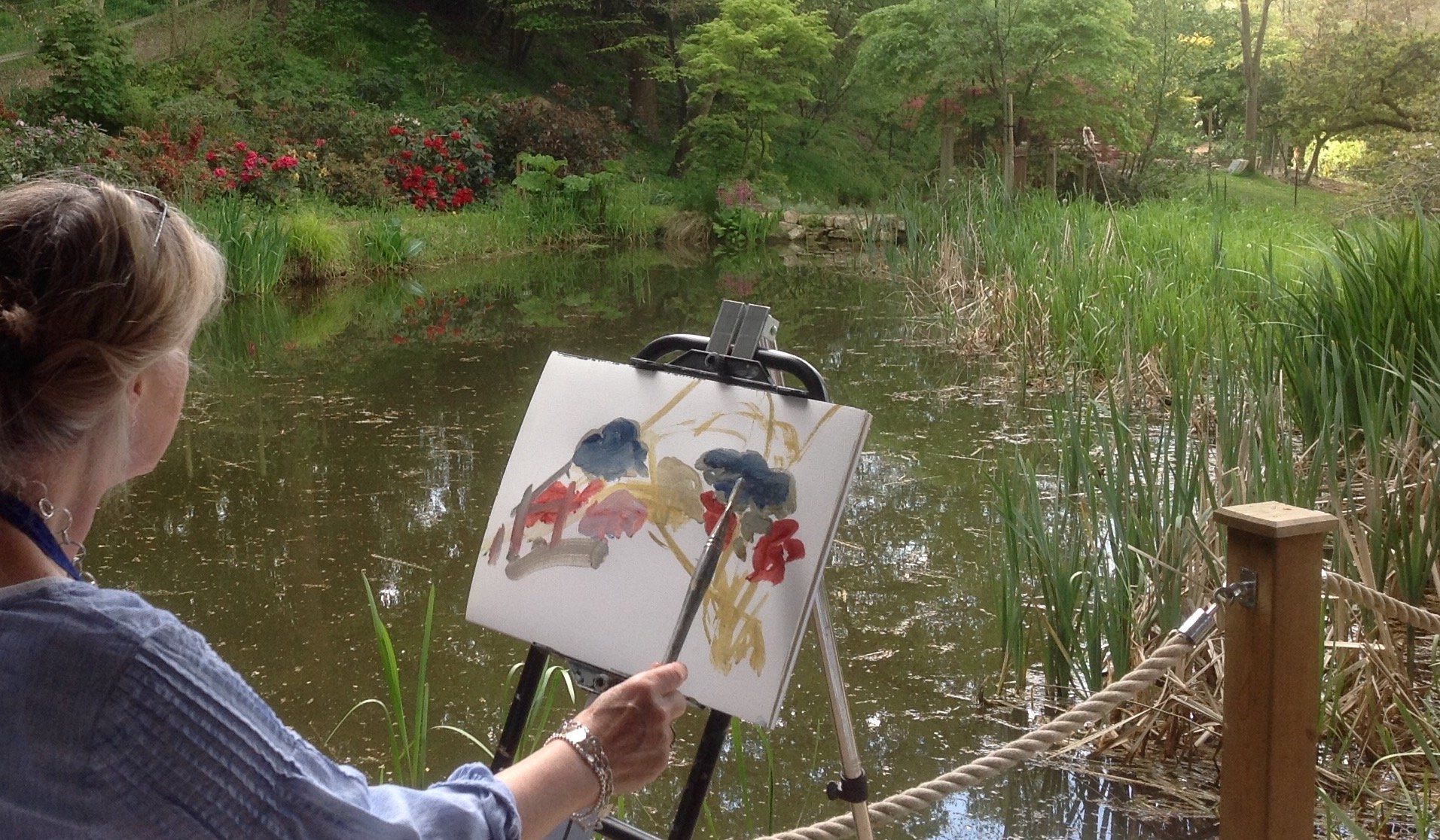 an Artist is interpreting the woodland surroundings with splash of vibrant colours