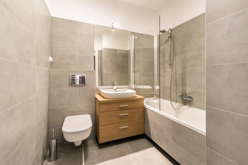 Modern bathroom with tiles on the floor in stylish apartment