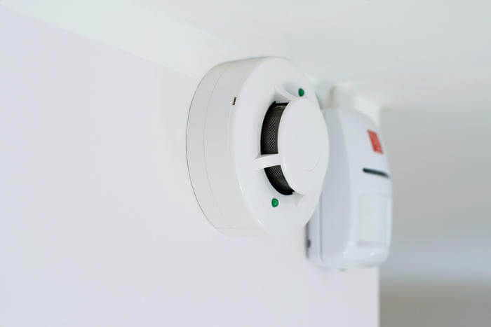 smoke detector and alarm mounted on a wall
