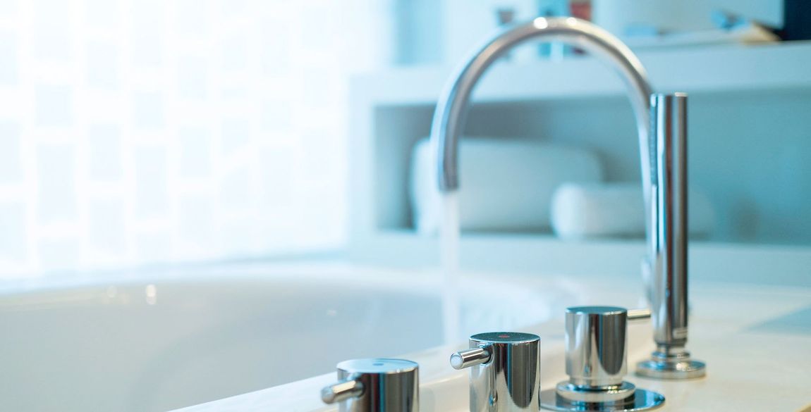 Bathtub faucet with running water,shallow focus.