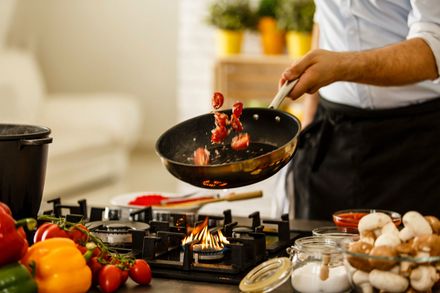 Chef tossing vegetables from cooking pan