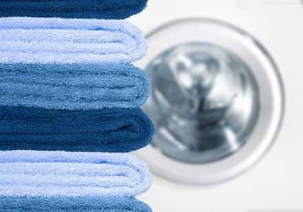 Pile of clean towels with washing machine