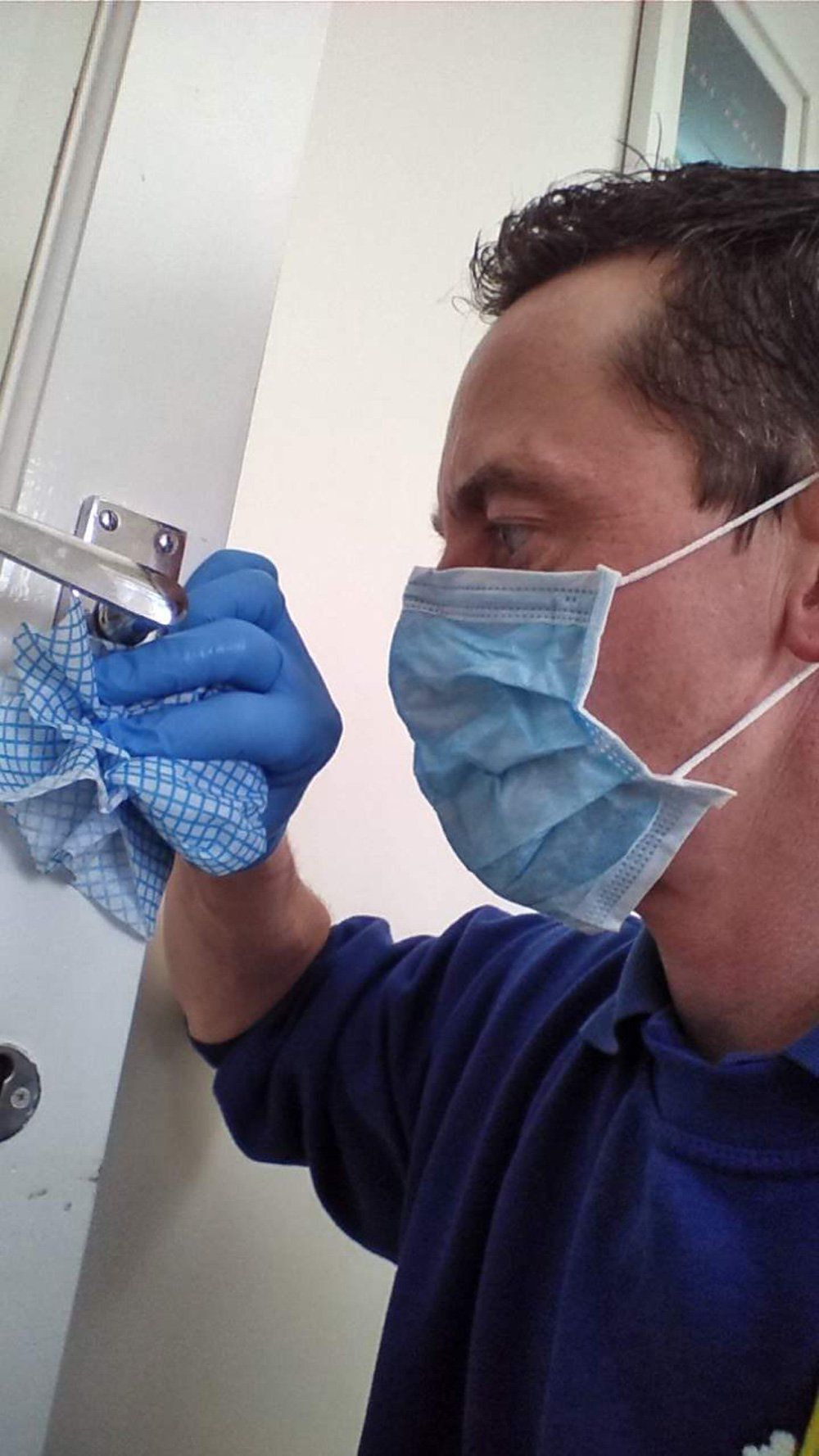 house-cleaner-with-mask-cleaning-door-handle