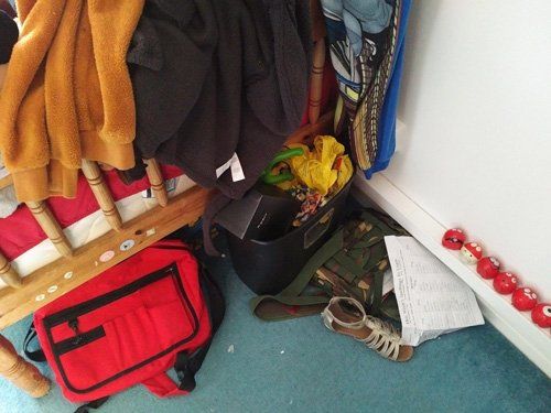 View of part of a Messy bedroom seen from end of bed