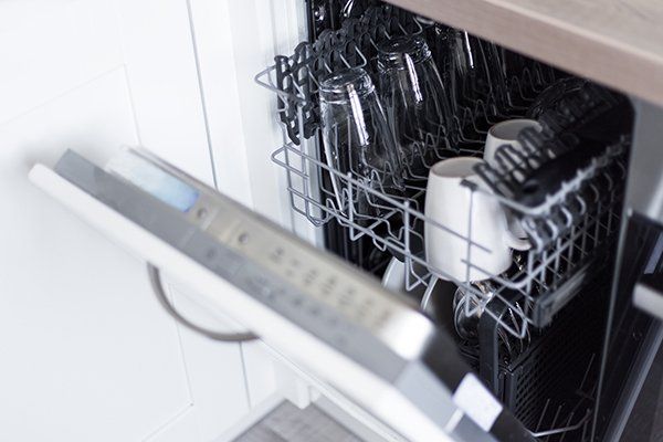 Open Dishwasher with Clean Glasses and Dishes — Cape Cod, MA — Cape Appliance Repairs Open Dishwasher with Clean Glasses and Dishes — Cape Cod, MA — Cape Appliance Repairs