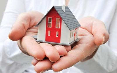 Home Insurance — Hands Holding a House Toy in Ontario, OH Home Insurance — Hands Holding a House Toy in Ontario, OH