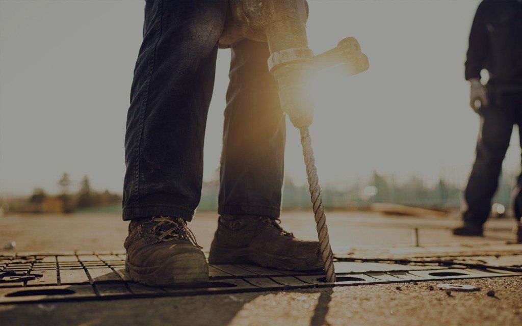 Man drilling with a large drill