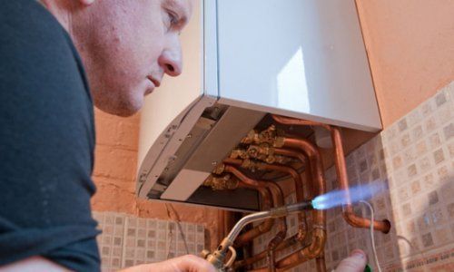 Plumber Working With a Blowtorch Covered by OnSite Insurance
