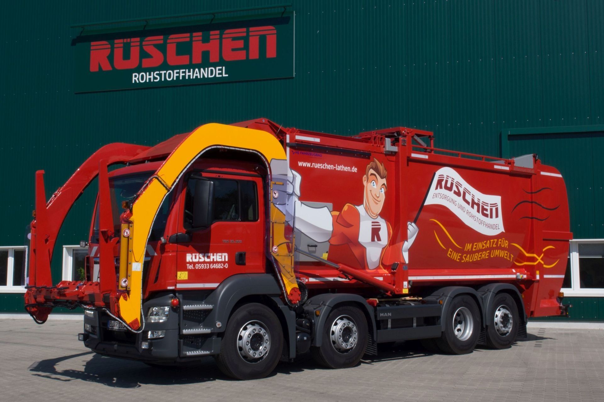Rüschen Frontlader Ein roter Frontlader mit dem Wort „Ruschen“ darauf