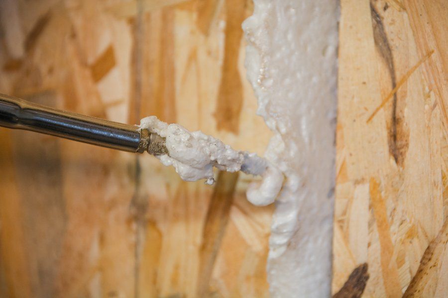 man doing weatherization on wall