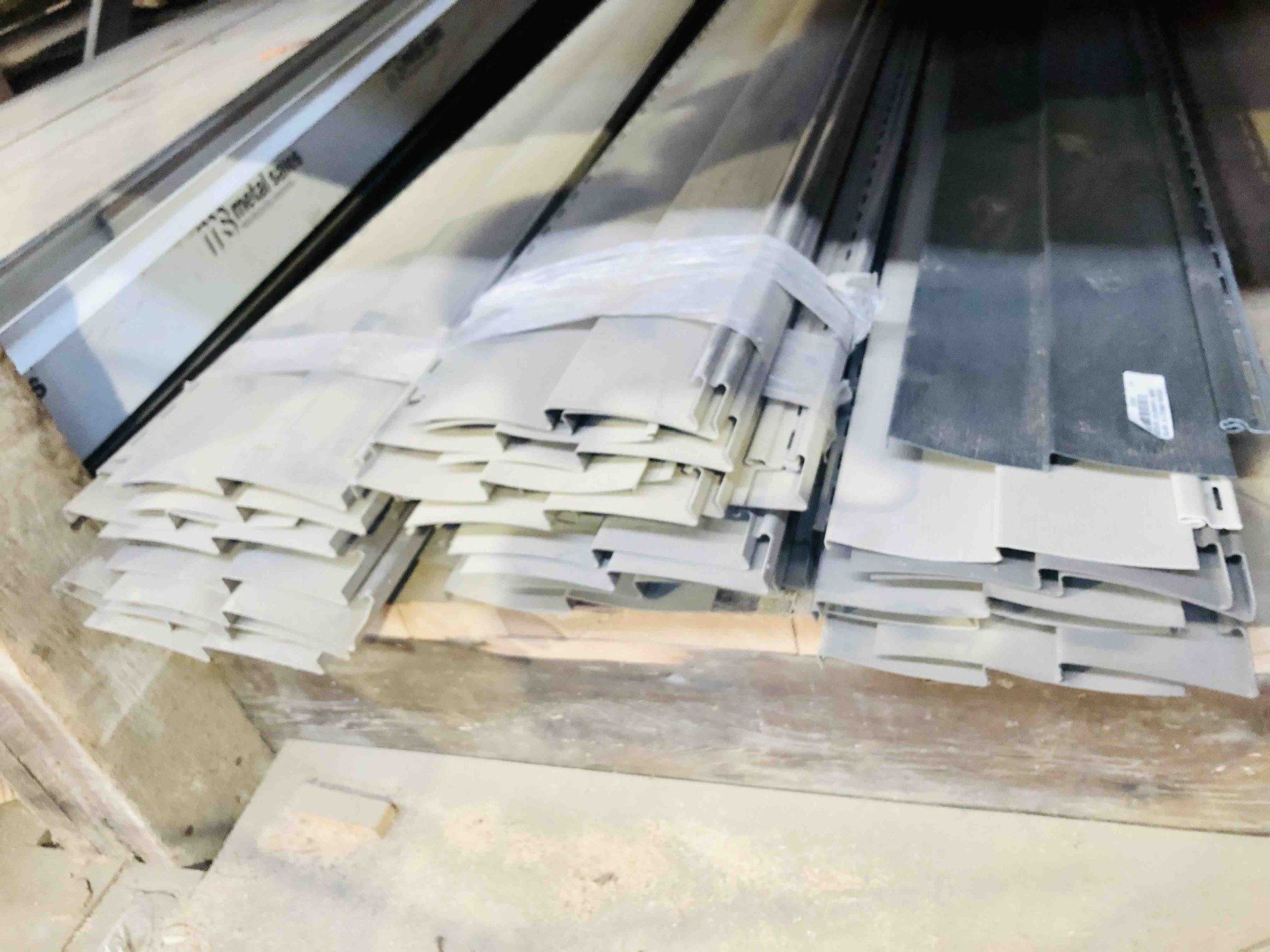 a bunch of metal pieces are stacked on top of each other on a wooden pallet.