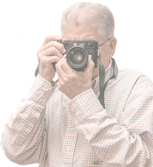 It's not important, but Chuck shoots with both Leica and Nikon digital cameras. Chuck Ramsay taking aim with the Leica M10 digital rangefinder camera. Self-portrait by Chuck Ramsay. Chuck Ramsay's career as an advertising manager and communications director spanned industries such as safety shoes, electronic component wholesaling, European tour travel and marketing, musical instrument advertising, motor and generator manufacture and marketing, insurance promotion and promotion, home improvement contracting advertising, land development promotion, and communications for the Bar Association of Metropolitan St. Louis.