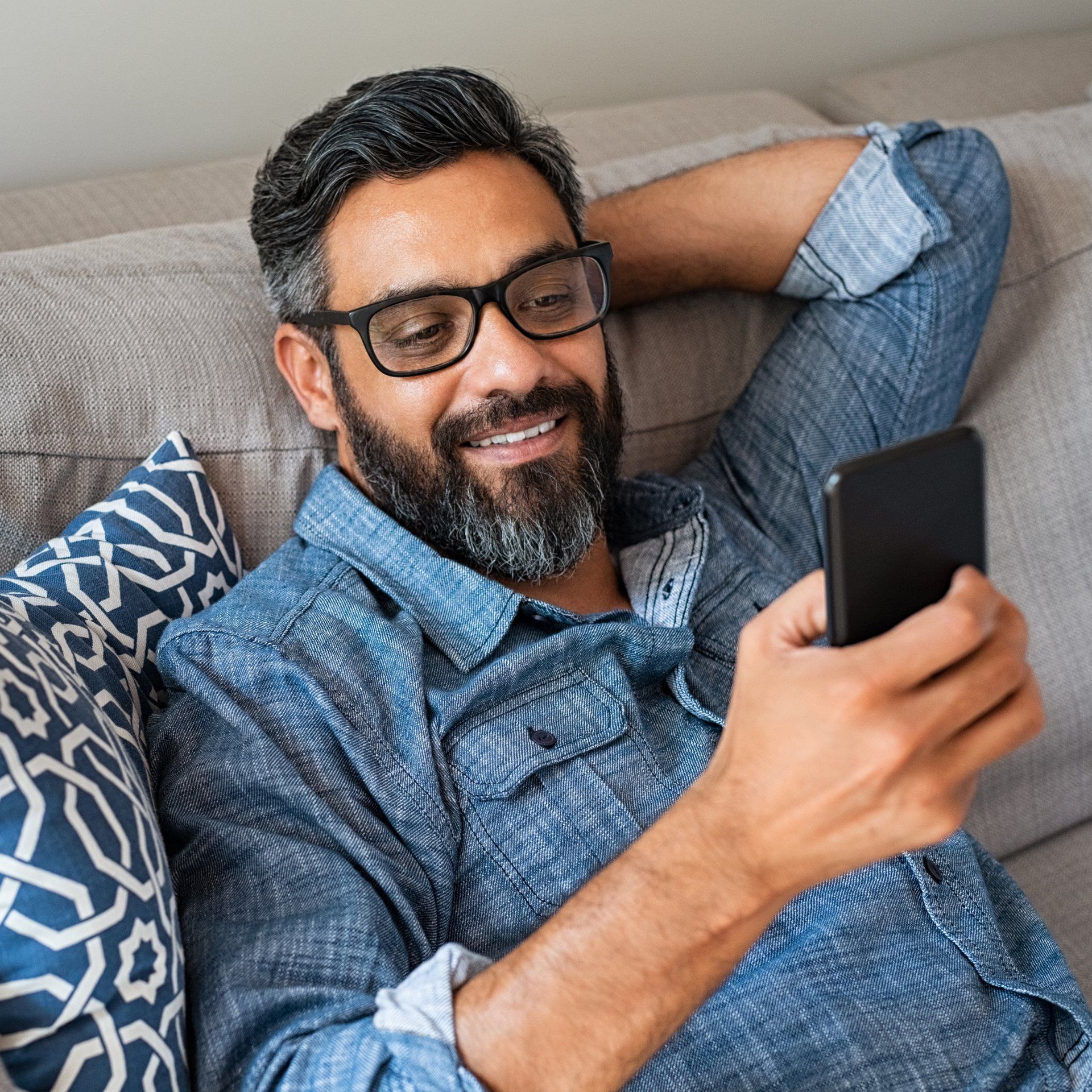 hispanic guy looking at his mobile