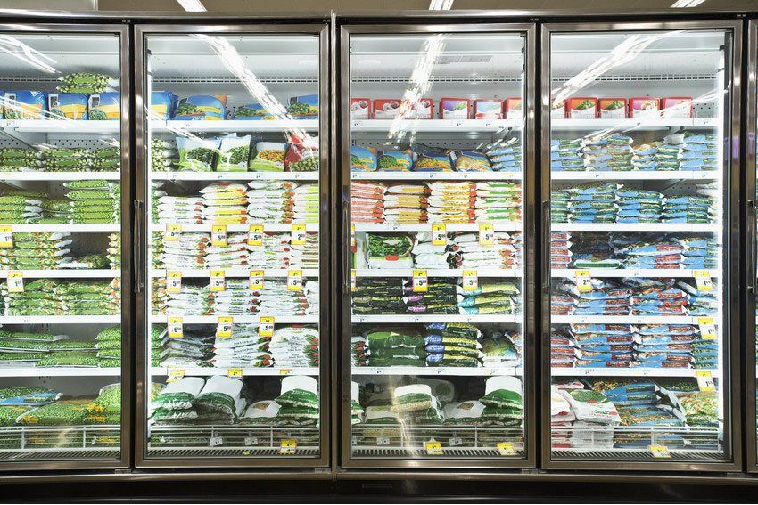 The dairy refrigerator in a small local supermarket, Miller's Farm Shop, Musbury, Devon.