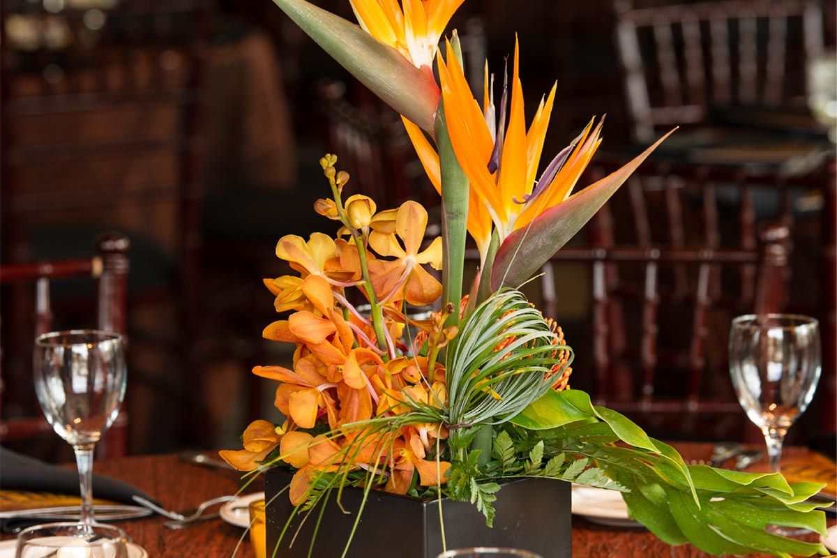 A table with flowers and wine glasses on it
