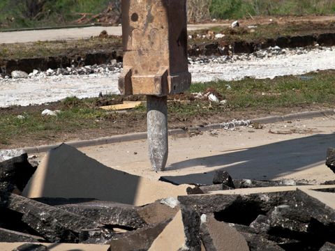 a heavy equip truck drilling the concrete
