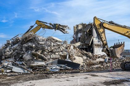 a trucks on the demolished structure