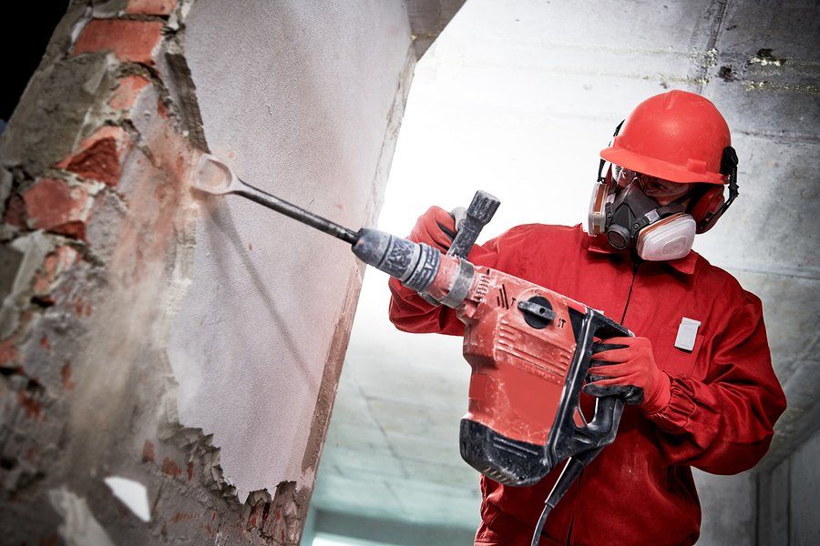 man demolishing the concrete wall