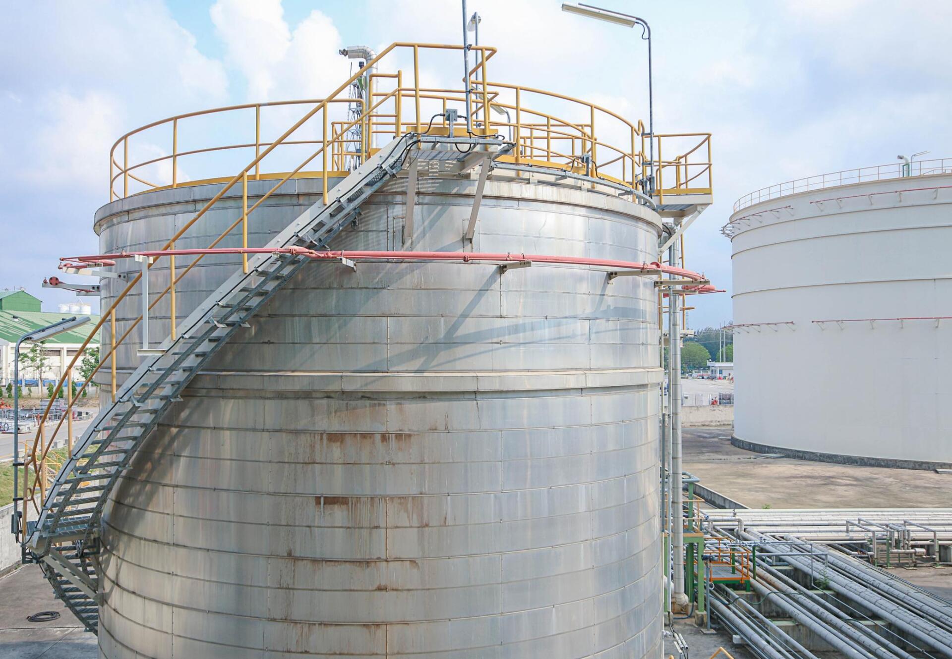 a huge storage tank with metal stair