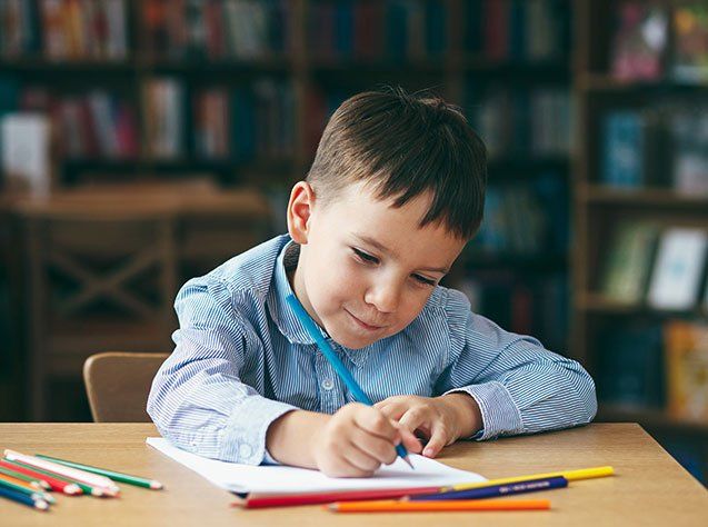 Child Development Facility — Preschool boy drawing in Oakland, CA