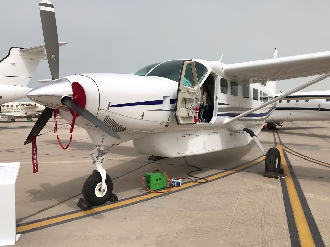 Red airplane being charged on ground