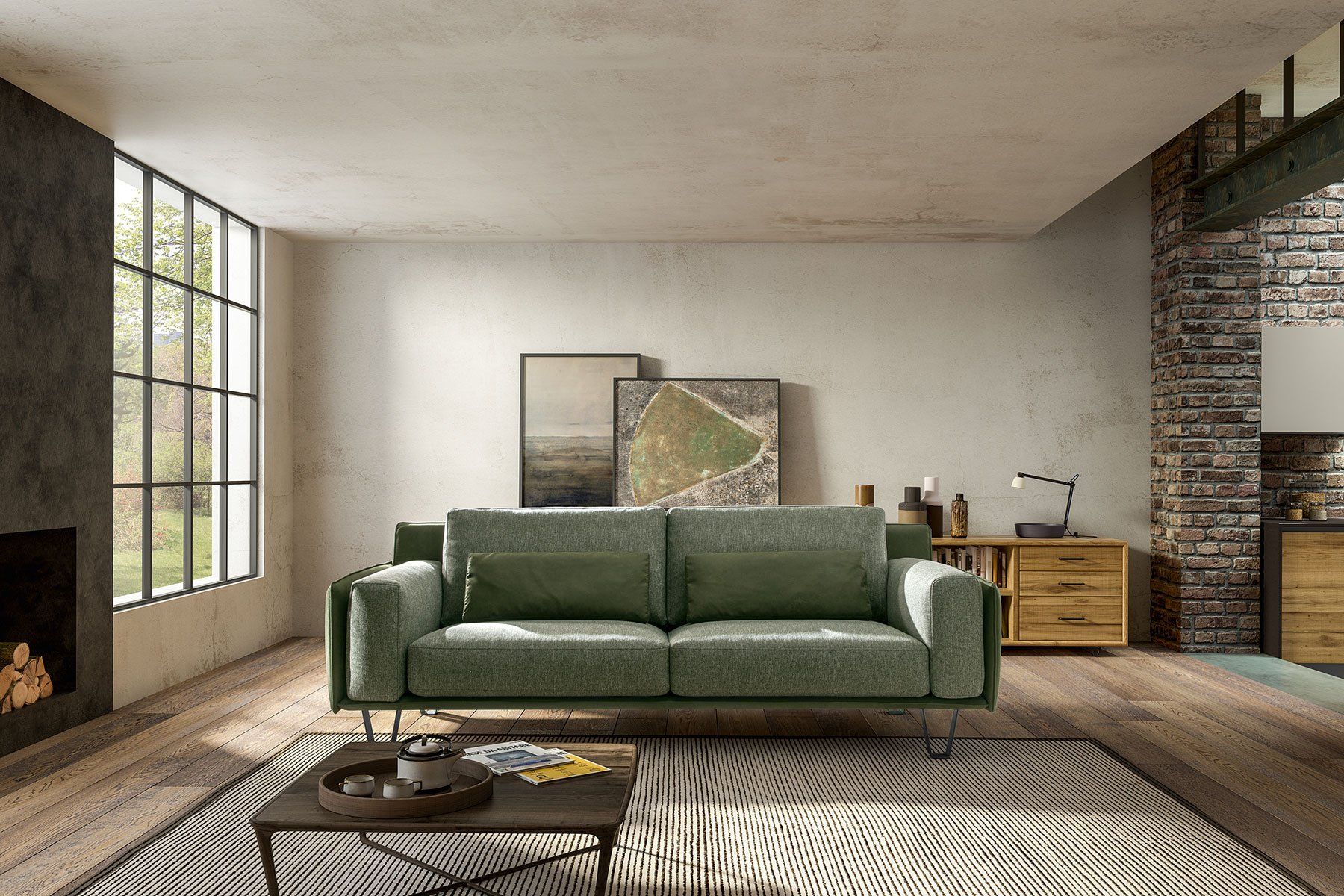 Soggiorno moderno con divano verde, ampie finestre, parete con mattoni a vista e tappeto intrecciato.