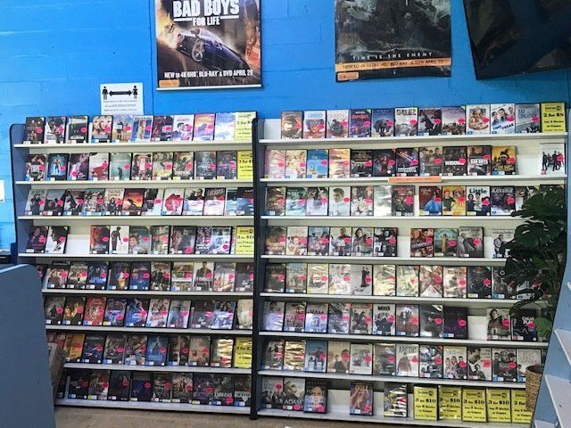 A Video Game Store With a Poster on the Wall That Says Bad Boys — West End Cash Store In Proserpine, QLD